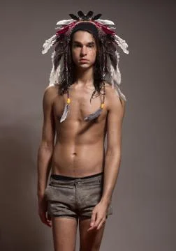 One young man posing shirtless war bonnet hairstyle Stock Photos