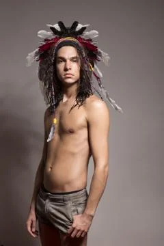 One young man posing shirtless war bonnet hairstyle Stock Photos