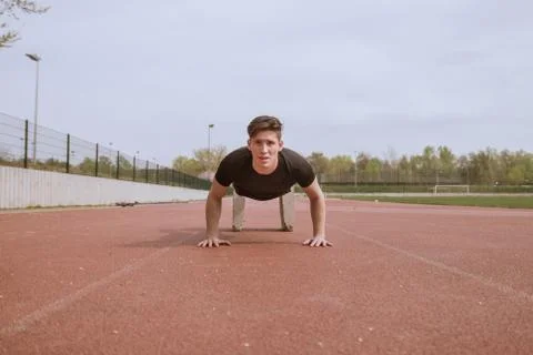 One young man, push ups, concrete block Stock Photos