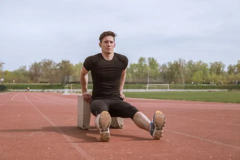 One young man, reverse plank dip, concrete  block Stock Photos