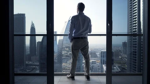 One Young Man Standing on Office Balcony Overlooking City Skyline Stock Footage 103588273