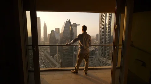 One Young Man Standing on Office Balcony Overlooking City Skyline Stock Footage 103588433