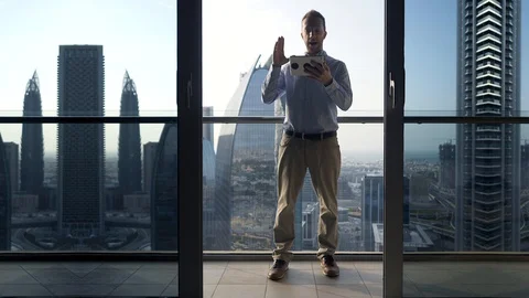 One Young Man Standing on Office Balcony Overlooking City Skyline Stock Footage 103588484