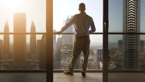 One Young Man Standing on Office Balcony Overlooking City Skyline Video stock 103588549