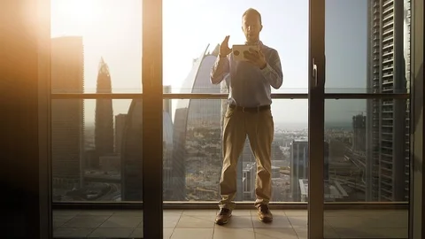 One Young Man Standing on Office Balcony Overlooking City Skyline Stock Footage 103588608