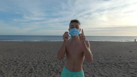 One young man taking off his mask for the coronavirus and starting running to th Stock Footage 143362746