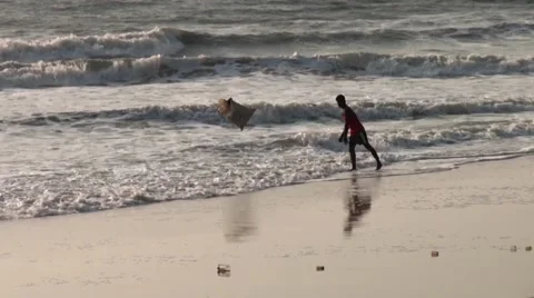 One young man throwing into the sea a bag of garbage Stock Footage 40516703