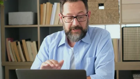 One young man working at home in the office with laptop and notebook taking note Vídeo Stock 151322284