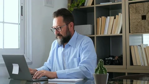 One young man working at home in the office with laptop and notebook taking note Stock Footage 166244334