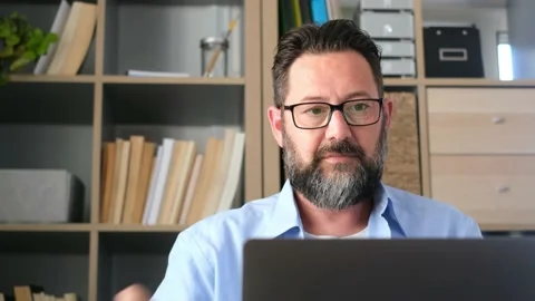 One young man working at home in the office with laptop and notebook taking note Stock Footage 166244424