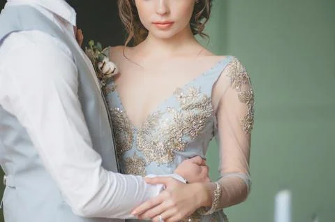 One young slim bride dressing in lace wedding dress preparing for ceremony Stock Photos