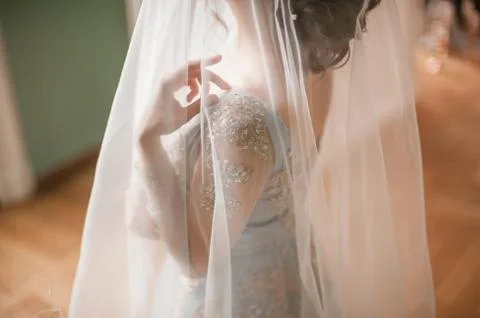 One young slim bride dressing in lace wedding dress preparing for ceremony Stock Photos