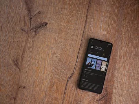 One Zero app play store page on smartphone on wooden background Stock Photos