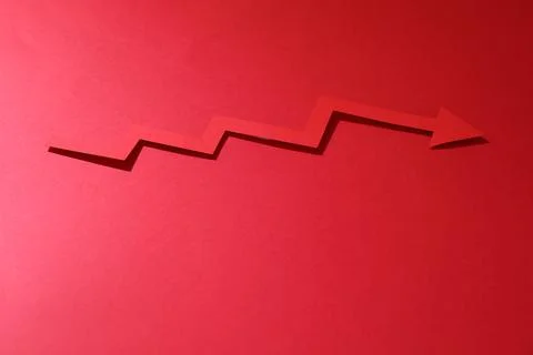 One zigzag paper arrow on red background. Space for text Stock Photos