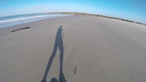 Onewheel POV Beach Shadow Gliding Floating Sand Sunny  Stock Footage 289572749