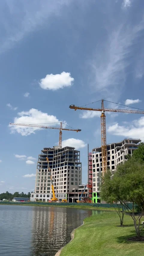 Ongoing construction of two buildings between green area Stock Footage 336975401