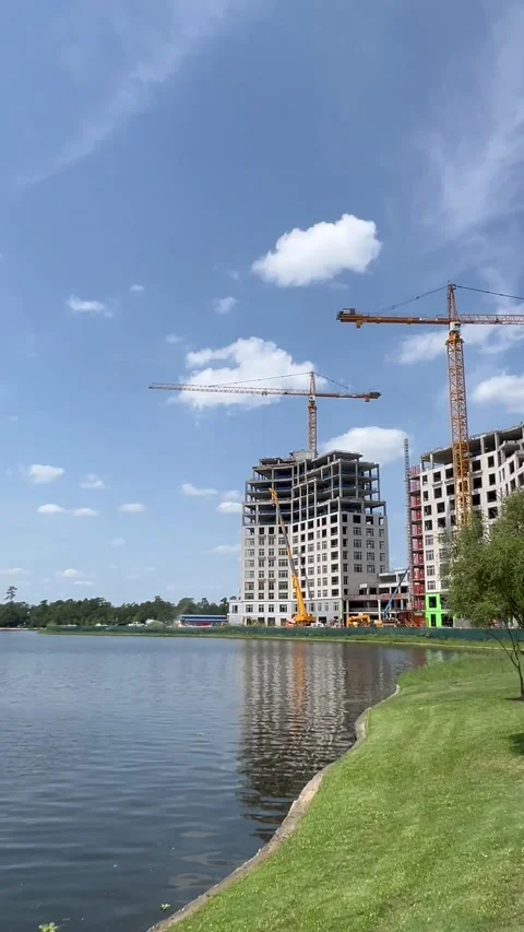 Ongoing construction of two buildings between green area Stock Footage 337129915