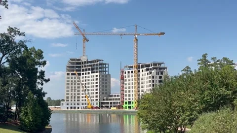 Ongoing construction of two buildings between green area Stock Footage 337266077