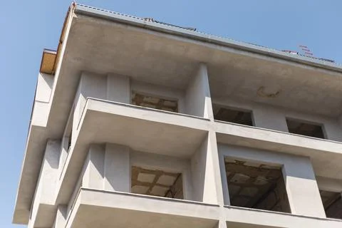 Ongoing construction work on a multi-story building with incomplete facades.. Stock Photos