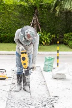 Ongoing roadwork under construction using jackhammer equipment. Stock Photos
