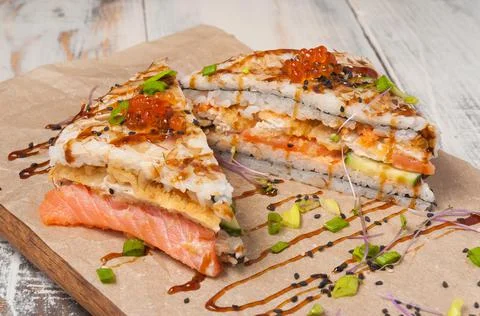 Onigirazu sushi with salmon, deep-fried white fish, cucumber, red caviar and  Stock Photos