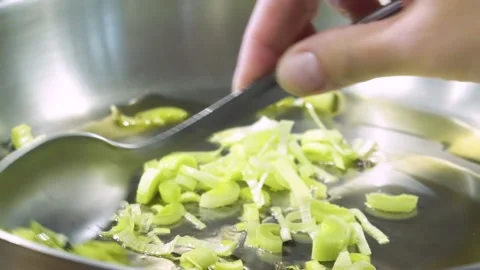 Onion and garlic fried in a pan. Fresh cut raw healthy food in a pot. Stock Footage 150590699