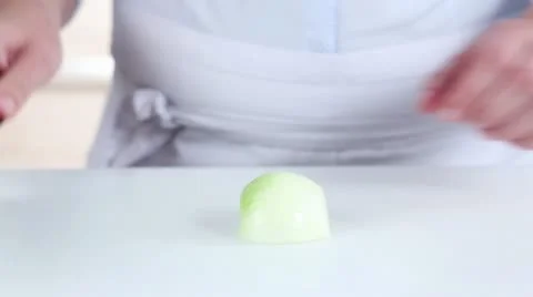 An onion being halved and chopped Stock Footage 24671137