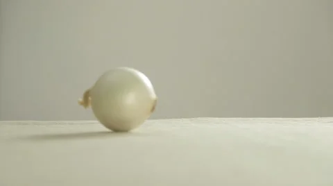 Onion Bulb Rolling on Table Stock Footage 50953916