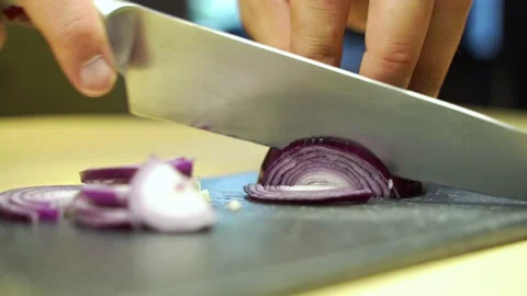 Onion cutting process. A man holds a vegetable in his hands. Stock Footage 135838147
