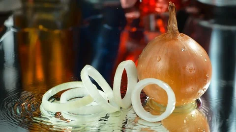 Onion that falls on the water and makes a splash. Slow motion, 4k Stock Footage 114985311
