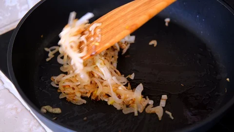 Onion fried in the pan Stock Footage 128412996