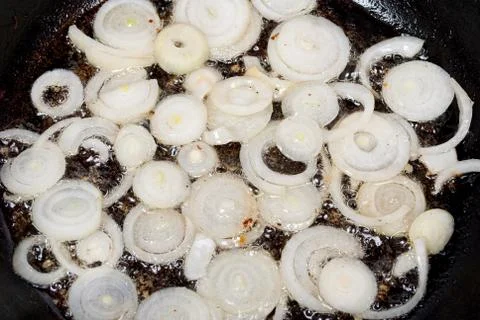 Onion fried in a pan Stock Photos