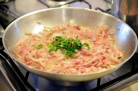 Onion fried in a pan Stock Photos