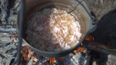 Onion fried in a pot. cauldron at the stake. camping in the wood. Stock Footage 113279390