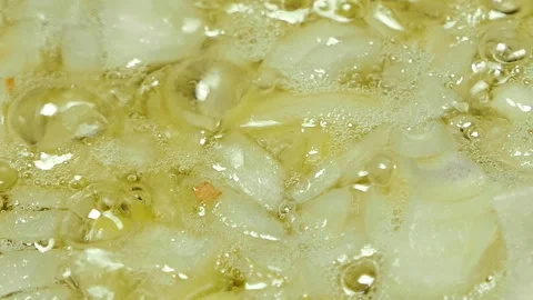 Onion is fried in vegetable oil in a pan Stock Footage 104809942
