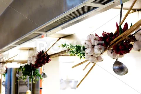 Onion an garlic braid hanged in kitchen Stock Photos