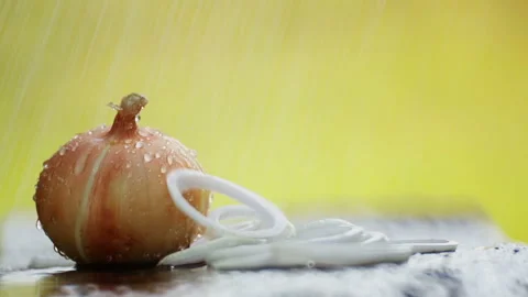 Onion head on the table under the drops of water. Stock Footage 114427178