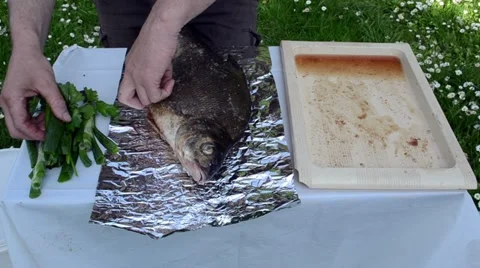 Onion leaf parsley thyme spice huge fish prepared bake foil Stock Footage 18181031