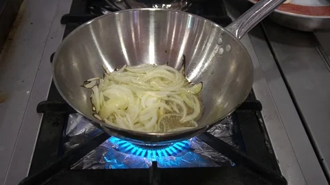 Onion Into Pan With Oil Stockbeeldmateriaal 105876889