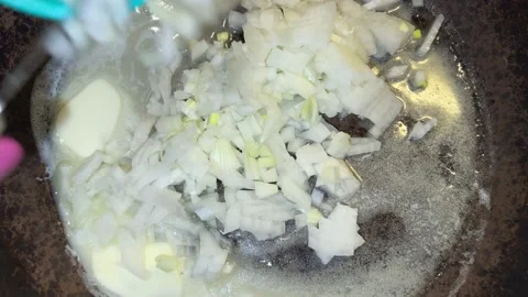 Onion is put in a pan with butter Video stock 221271318