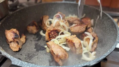 Onion is put in the pan with meat Video stock 232644301