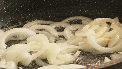 Onion rings being fried in a frying pan with vegetable oil Stock Footage 319954701