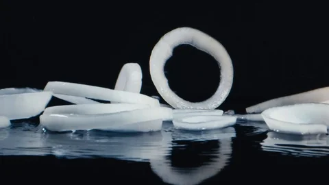 Onion rings fall to the surface Stock Footage 117398858