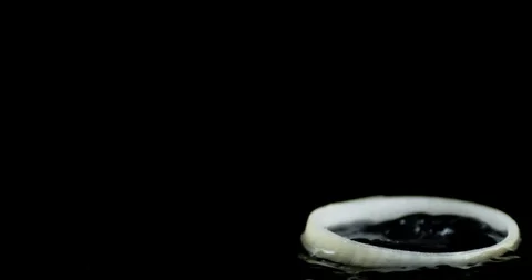 Onion rings fall on the water with splashes. Stock Footage 129412445