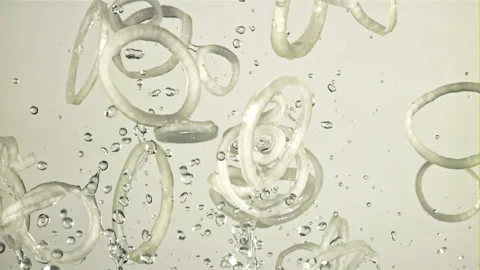 Onion rings fly up and fall down. Filmed on a high-speed camera at 1000 fps. Stock Footage 202144163
