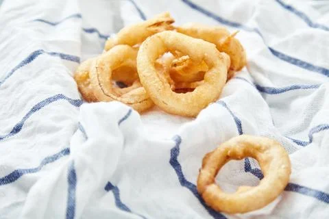 Onion rings on kitchen towel Stock Photos