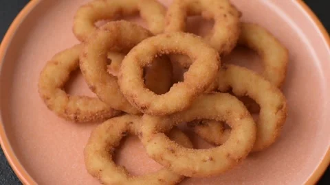 Onion rings or fried squid in breadcrumbs with sauce, takeaway food. Onion rings Stock Footage 318577646