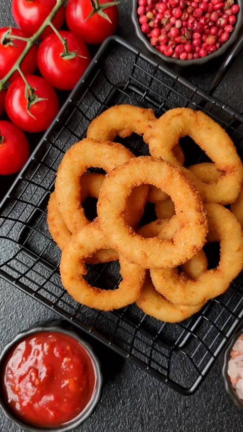 Onion rings or fried squid in breadcrumbs with sauce, takeaway food. Onion rings Stock Footage 318577723
