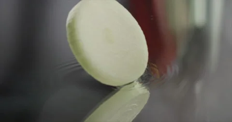Onion rings spin on a mirror surface Stock Footage 198147852