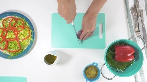 Onion slices on a cutting board. Vegetable salad on a plate Stock Footage 118512880